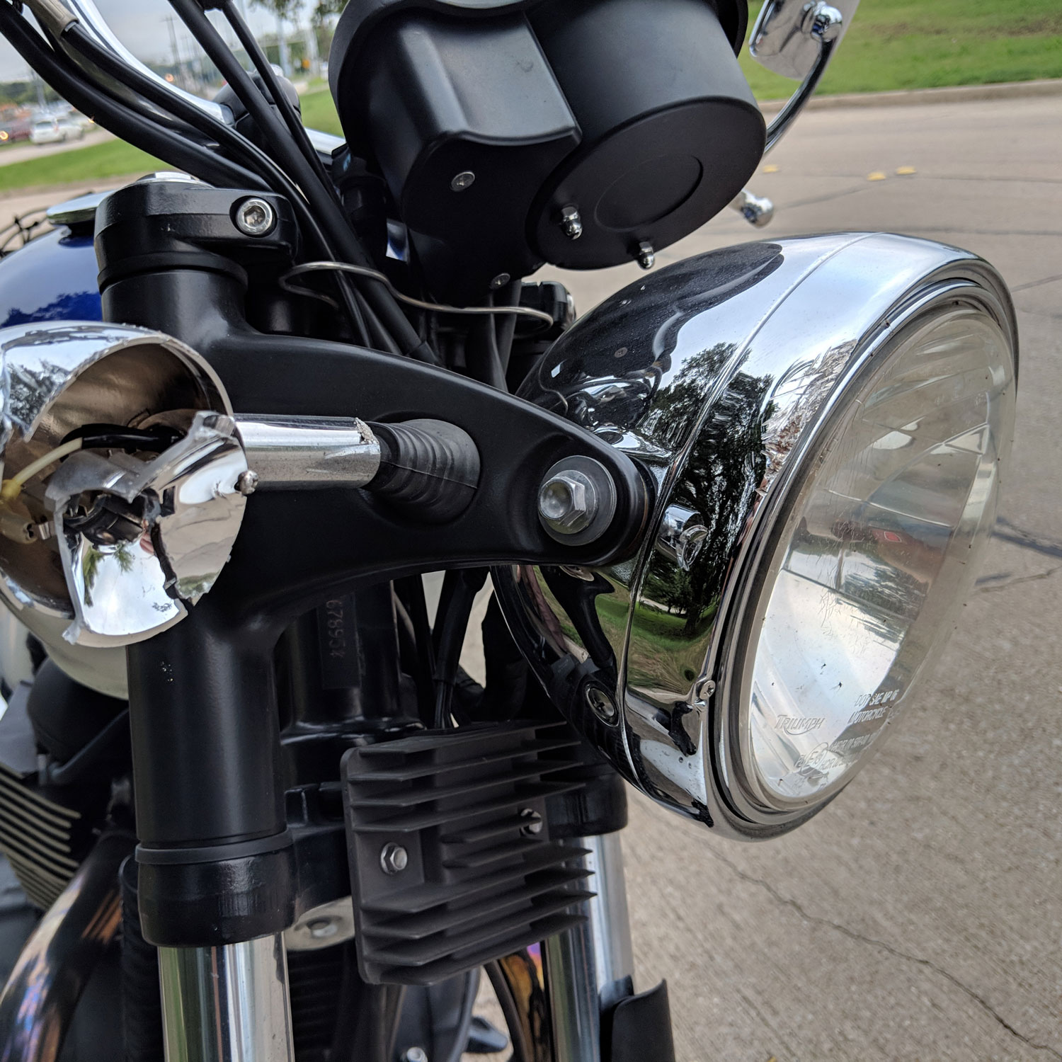 Damaged right turn signal on Triumph Bonneville.