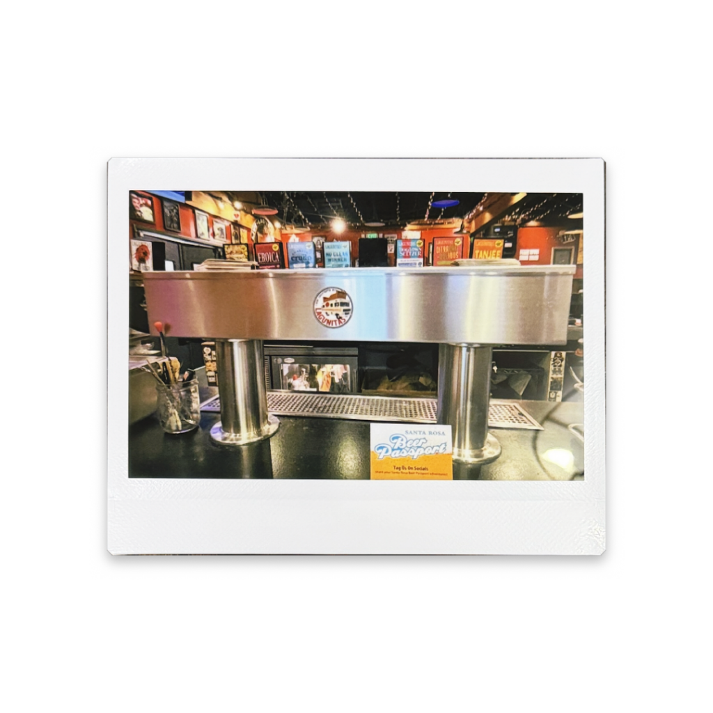 Instax Wide photo of 8-tap stainless steel beer tower on a bar